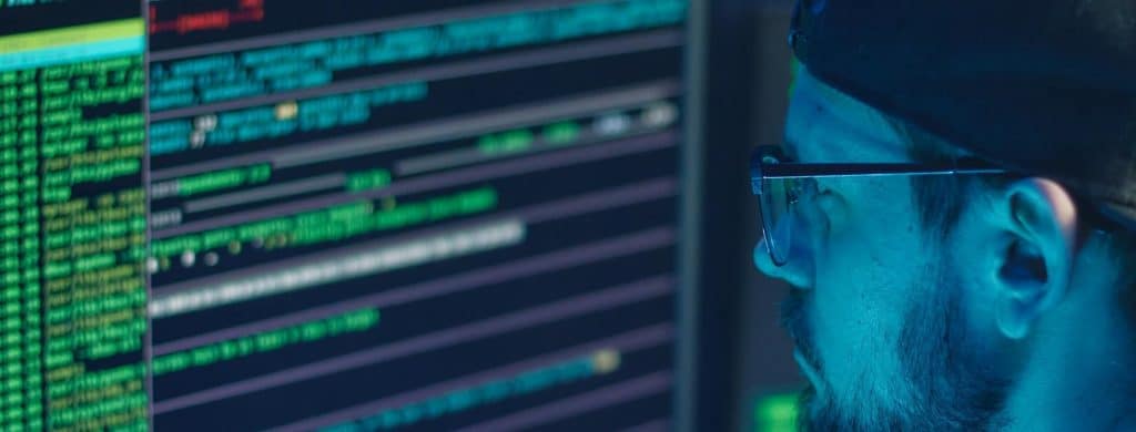 Security expert looking at laptop screen wordpress security audit checklist